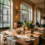 An elegant dining room in the Condesa with arched windows, a long set table, and guests seated around it.