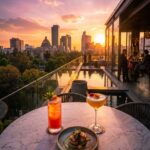 Golden sunset over Condesa and Mexico City, with rooftop cocktails, gourmet dining, and a reflective pool beside the skyline.